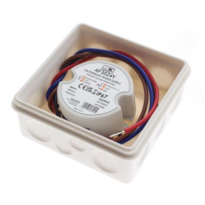 Linjeteckning av en cylindrisk LED-styrenhet, diameter 67 mm, höjd 25 mm, med två sidokablar. Idealisk för LED-belysningsinstallationer.