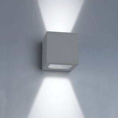 En minimalistisk vägglampa som lyser upp och ner på en grå vägg och framhäver modern LED-belysning i din inredning.
