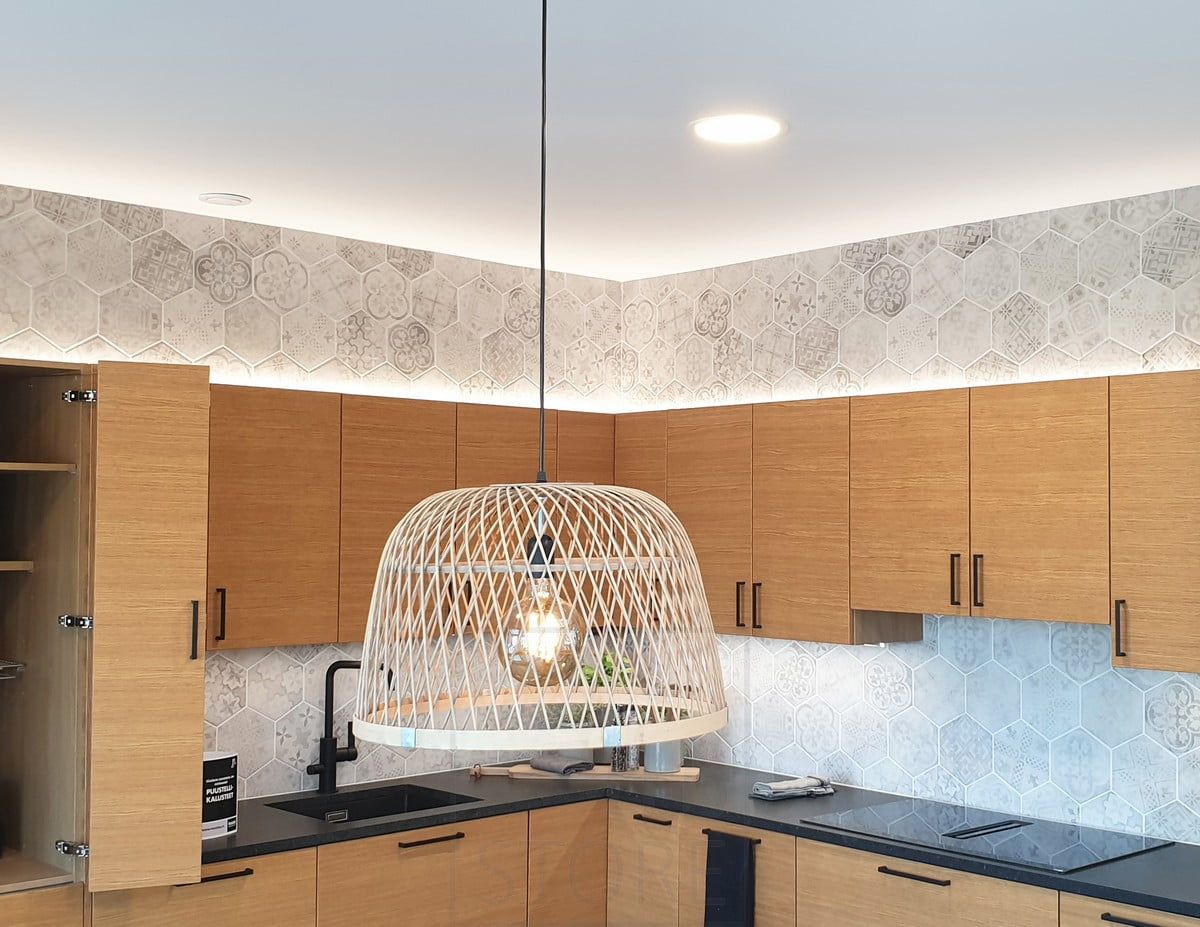 Housing Fair 2020: indirekt belysning i köksskåpet ovanpå ek-köket. Plafonder i taket och en pendellampa ovanför matbordet. Ledstore.fi