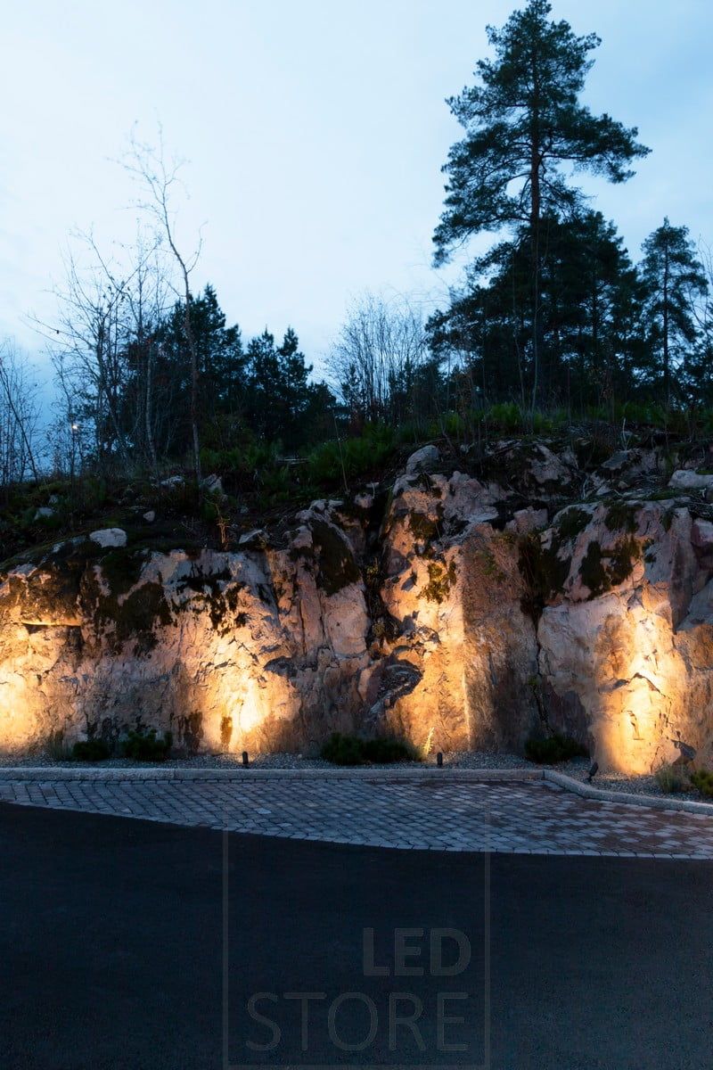 Markbelysningen SPIKE belyser en sten med stämningsfullt, indirekt ljus. Ledstore.fi