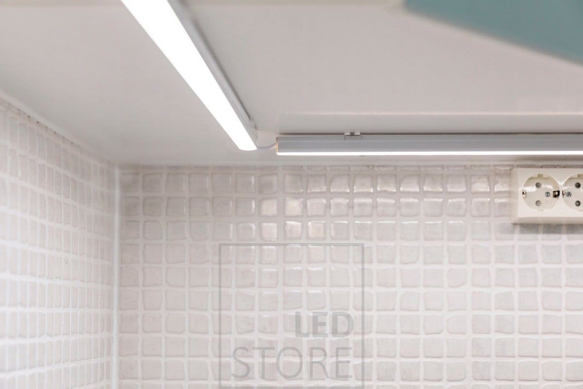 Närbild av en bänkskiva med led-belysning. Den högre ytprofilen har en ledremsa inuti, den vinklade kabeln möjliggör en något friare placering av profilerna. Ledstore.fi