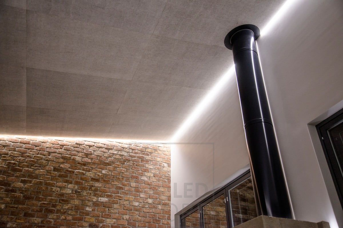 Mjuk, indirekt stämningsbelysning i taket i vardagsrummet. En LED-ljusremsa cirkulerar runt i rummet i ett spår mellan taket och väggen. Ledstore.fi