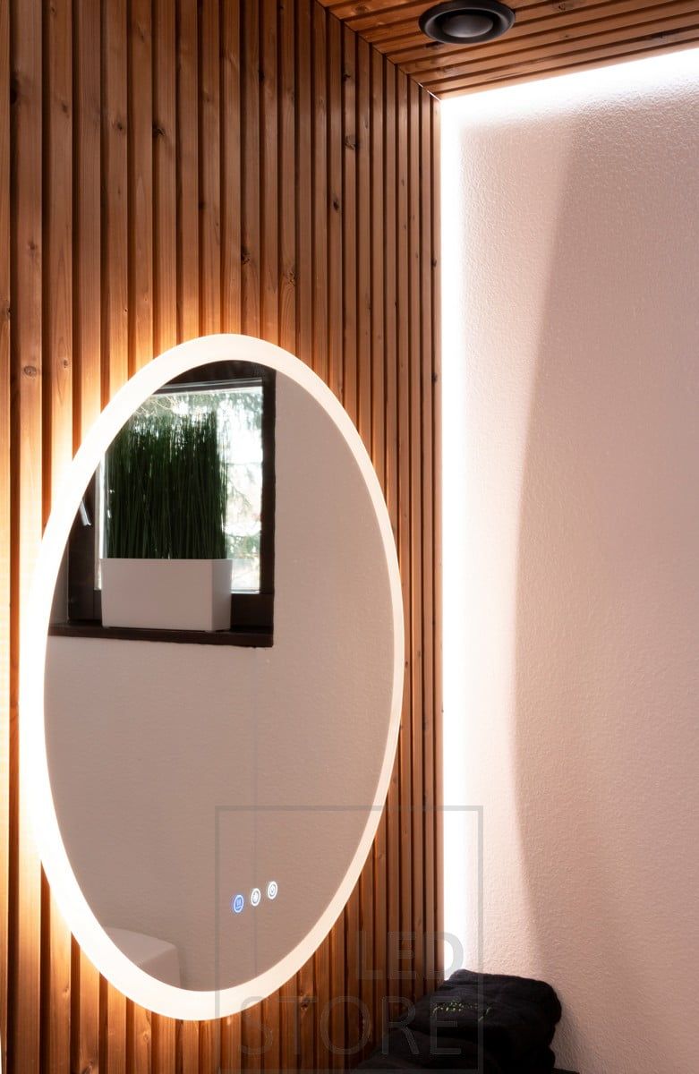 Ljus spegel som belyser genom väggen till sidorna, genom frosten till ansiktet, med ytterligare indirekt ljus bakom läkten med LED-list. Ledstore.fi
