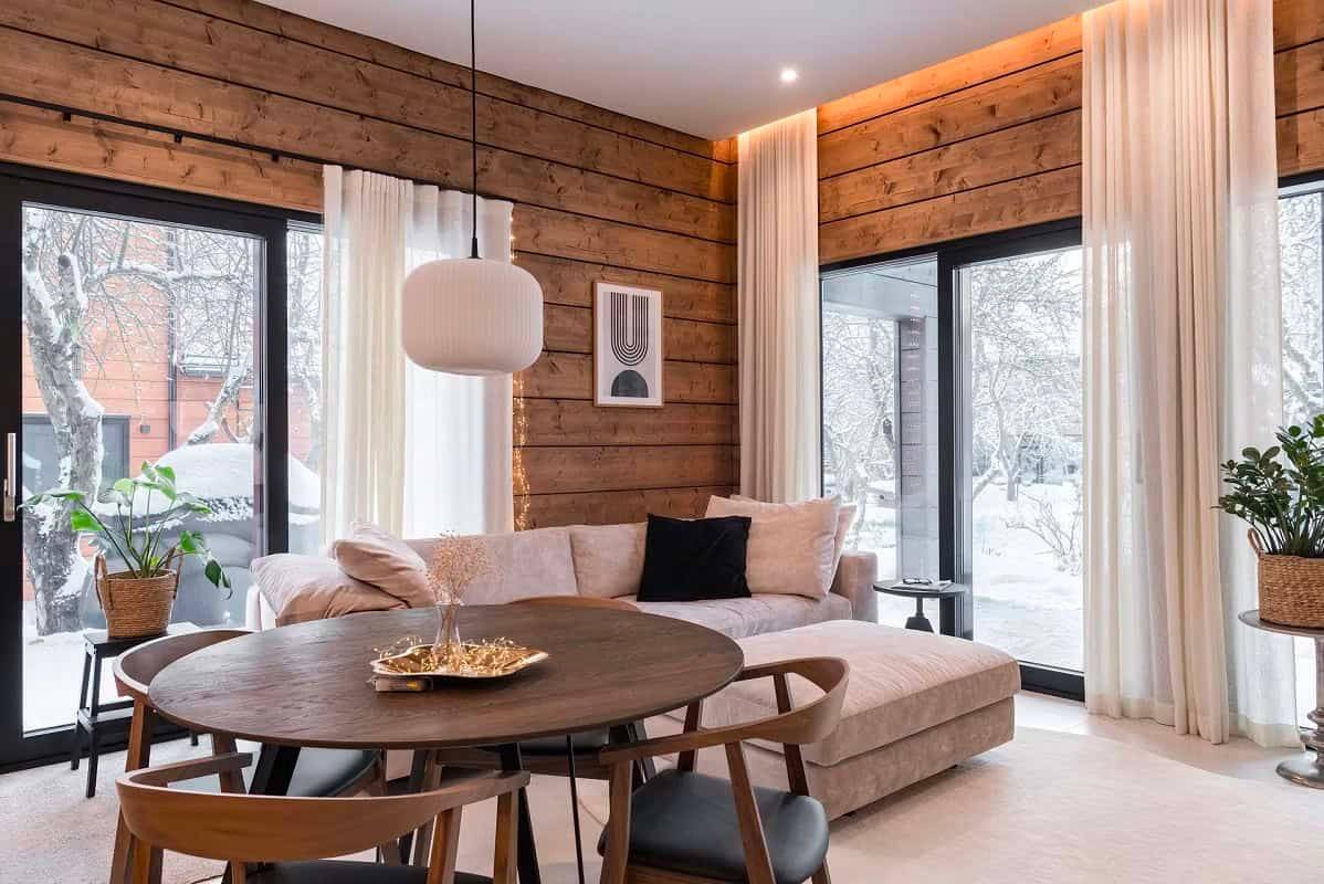 Ett modernt och varmt vardagsrum med LedStore.fi LED-downlights som framhäver träytorna och rummets arkitektur.